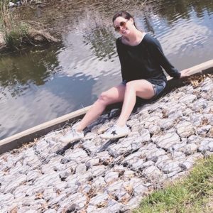 Pale girls sitting on some rocks